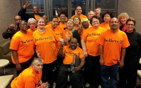 The Dallas Street Choir performed in T-shirts, then changed into formalwear for the Street Requiem. Baritone Russell Rodriguez is in front, far right, in an orange T-shirt.